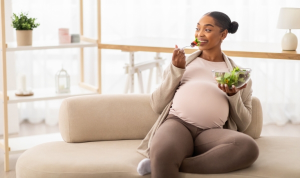 Pregnant woman enjoying salad