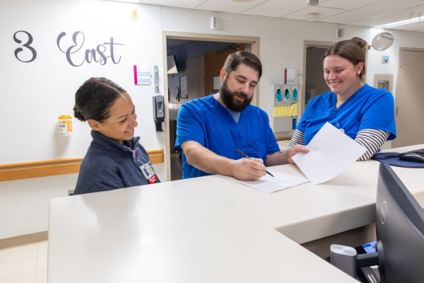 Giaccio conferences with his team members.