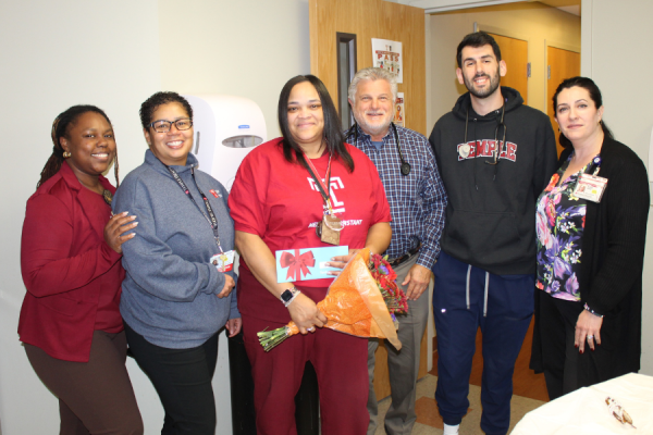Nyema celebrates her award with her colleagues.