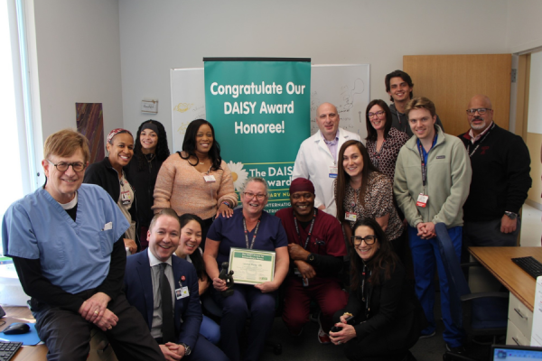 Lauren Reilly, RN (center) celebrates her DAISY Award with her colleagues.