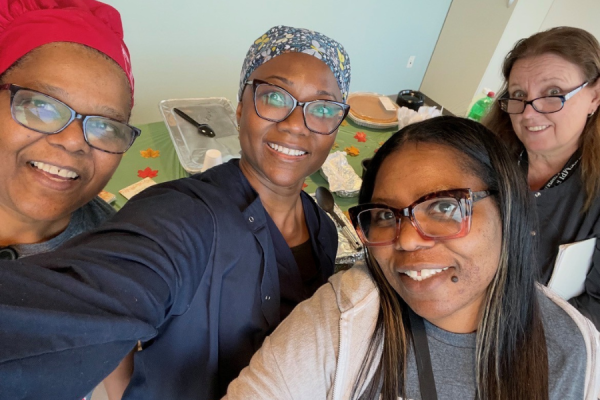 Chestnut Hill team members (with Campbell on the far left) snap a selfie while serving their homemade Thanksgiving meal.