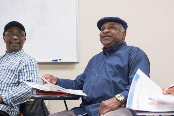 Men laughing and talking in diabetes prevention class