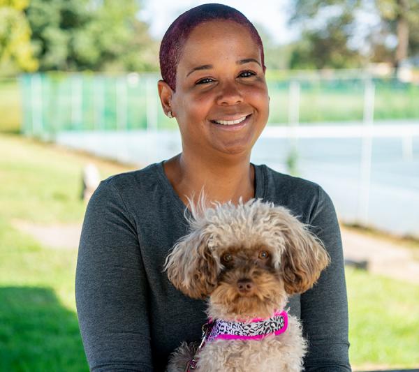 Closeup of bariatric patient, Marisol, holding her dog 